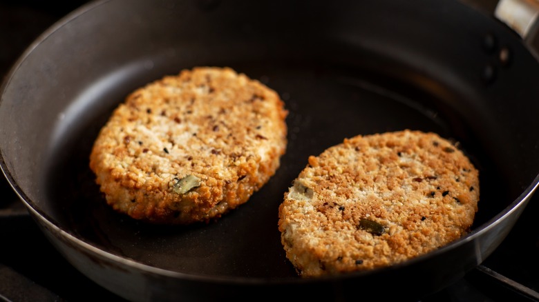 veggie burgers frying in pan