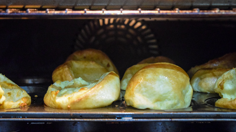 Yorkshire puddings rising in the oven 