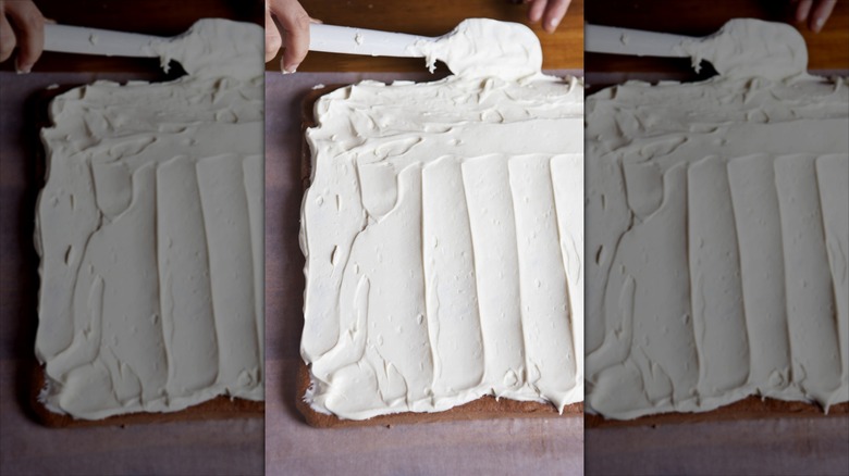 Spreading frosting on a Yule log