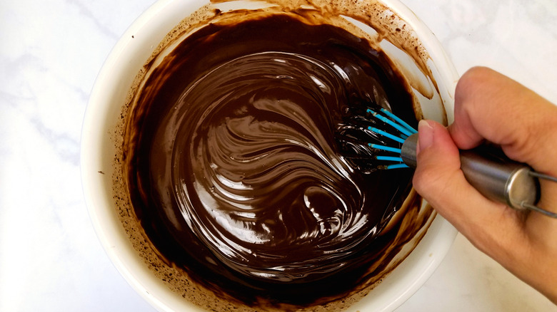 A hand making chocolate ganache