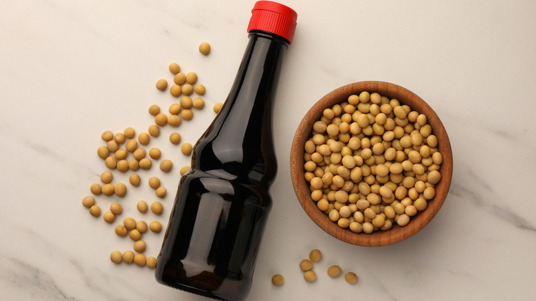 bottle of soy sauce and soybeans