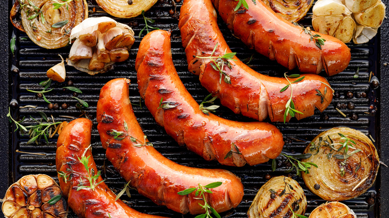 Cooking sausage and onions on a grill