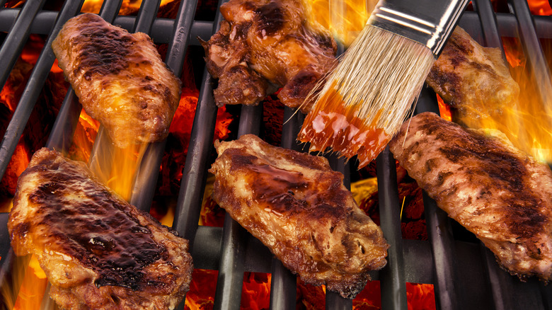 Brushing sauce on chicken wings