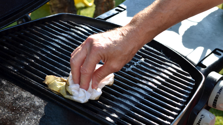 man cleaning a grill