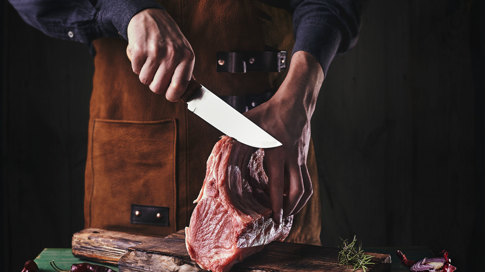 Cutting into the steak while cooking