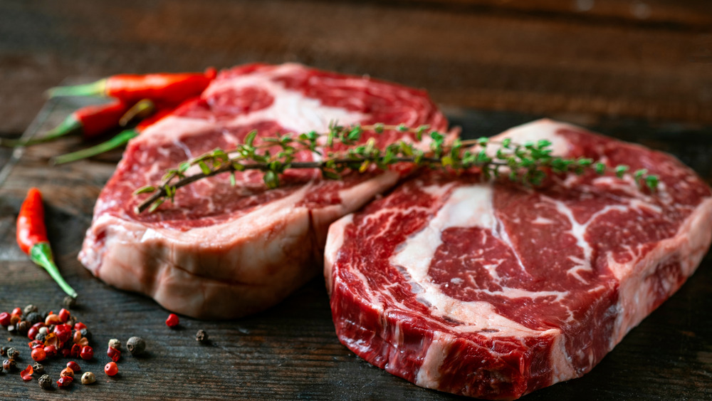 thick cuts of steak with thyme and chili pepper