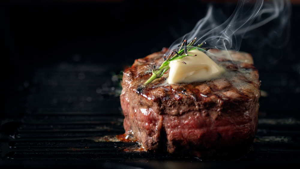 grilled steak with butter and herbs 