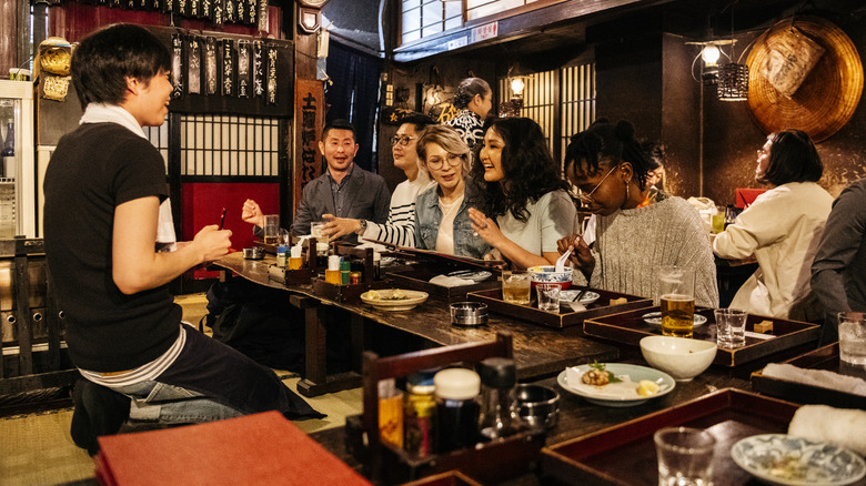 waiter taking order in Japanese restaurant