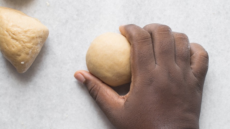 person making balls of pasta dough