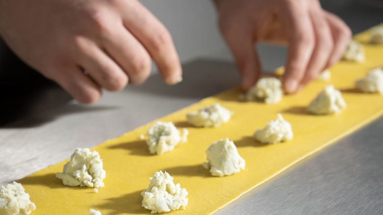 person assembling ravioli