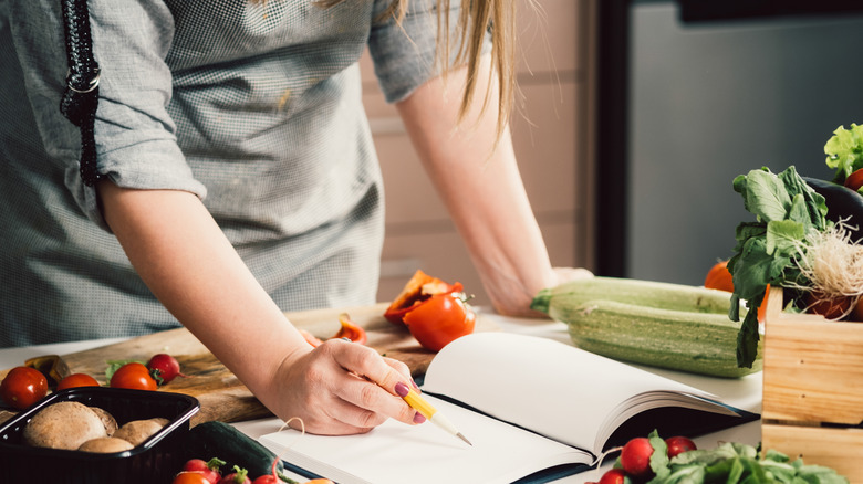 person looking at cookbook