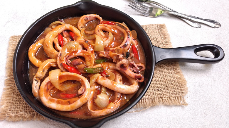 Stewed calamari rings in pan