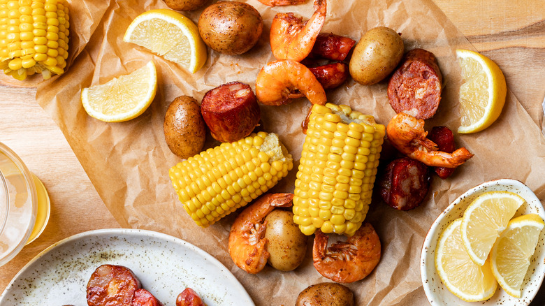 Shrimp, sausage, potatoes, and corn cobs with lemon slices