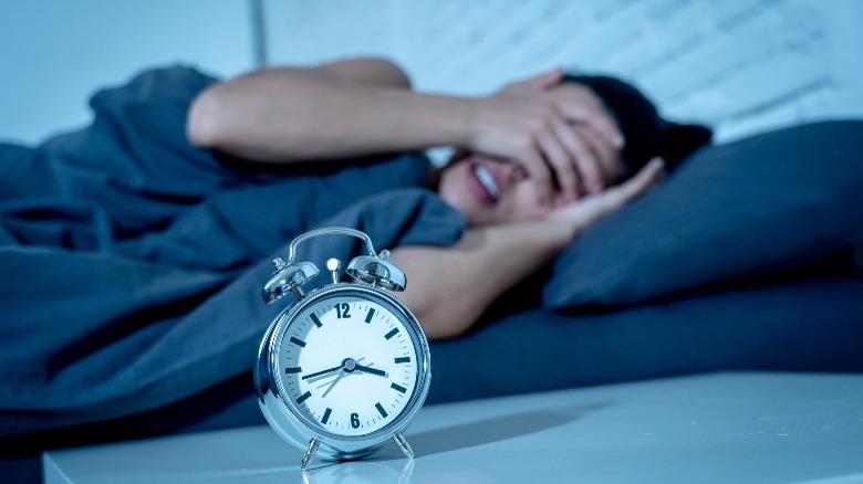 sleeping woman with clock 