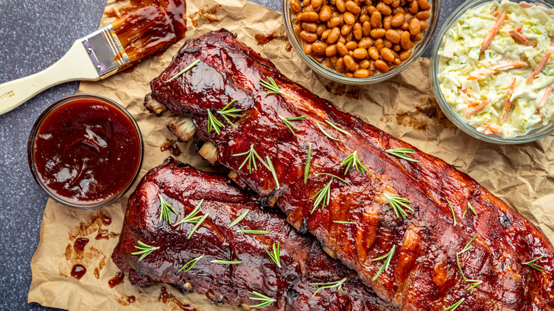 Ribs with sauces, coleslaw, and beans