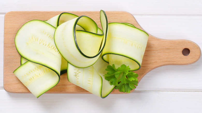 zucchini ribbons on cutting board