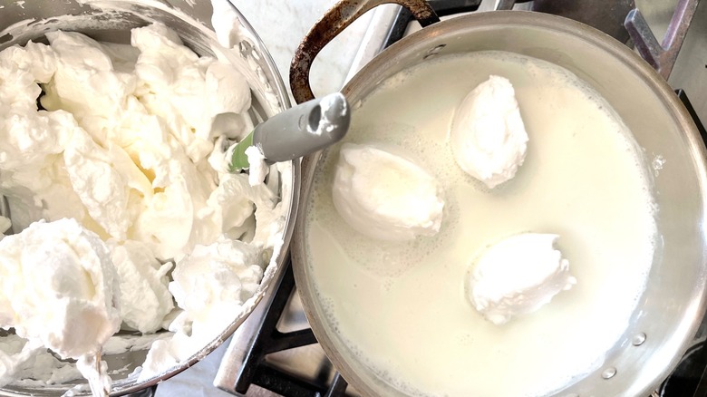 A bowl of meringue next to a pot