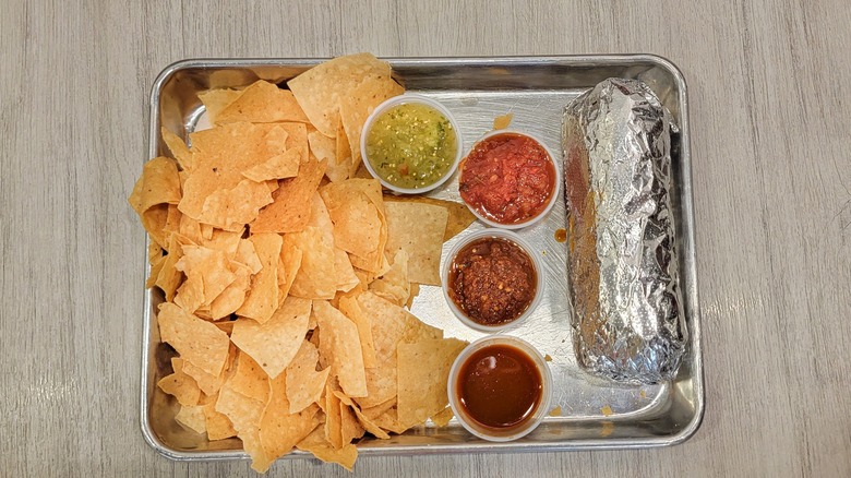 Moe's meal of burrito, chips and salsa on tray