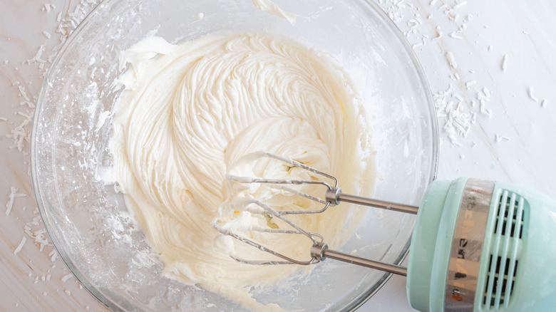 mixing coconut frosting