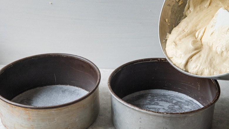 batter scraped into cake pans