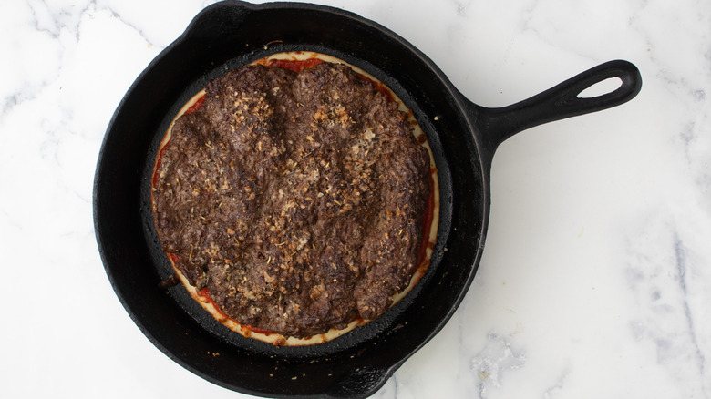 cooked beef layered in skillet