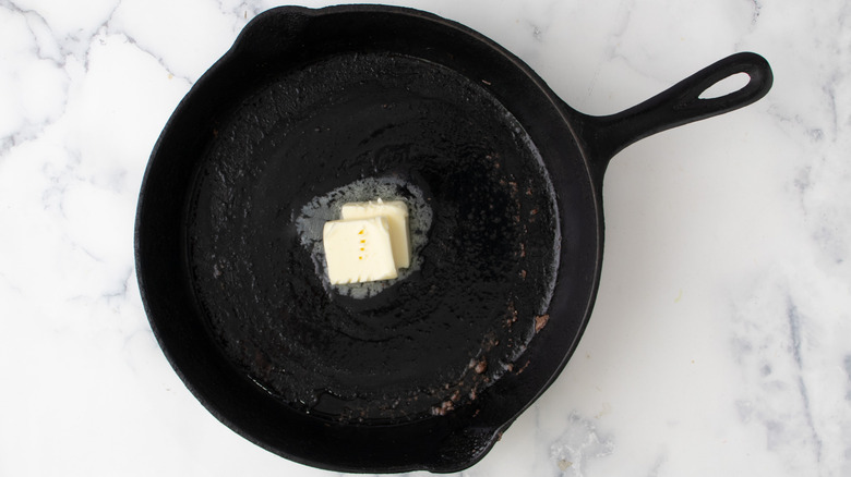 cubed butter melting in skillet