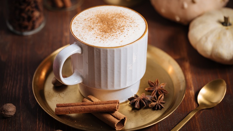 Pumpkin spice latte on metal saucer