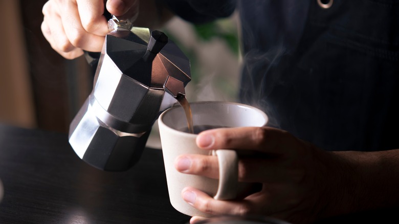 Person pouring coffee