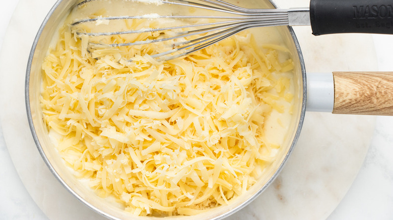 shredded cheese in white sauce