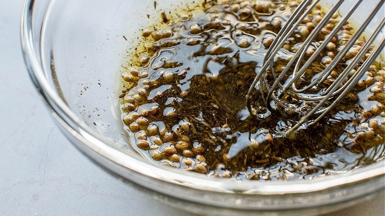 whisking seasonings in bowl