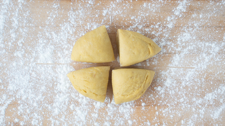 quartered ravioli dough on floured work surface