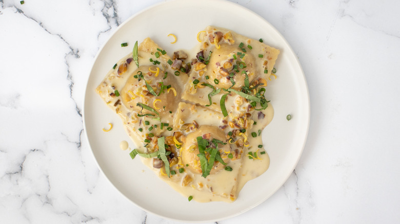 ravioli with pistachio cream sauce on plate