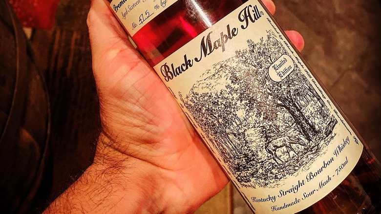 hand holding a bottle of Black Maple Hill 16 Year Old bourbon