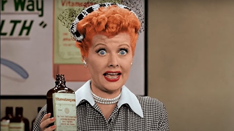 Lucille Ball holding Vitameatavegamin bottle