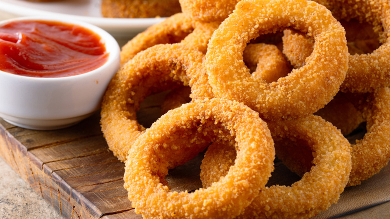 Fresh onion rings on a wooden board