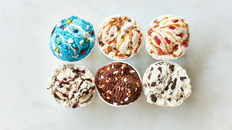 Six cups of ice cream with various flavors and toppings