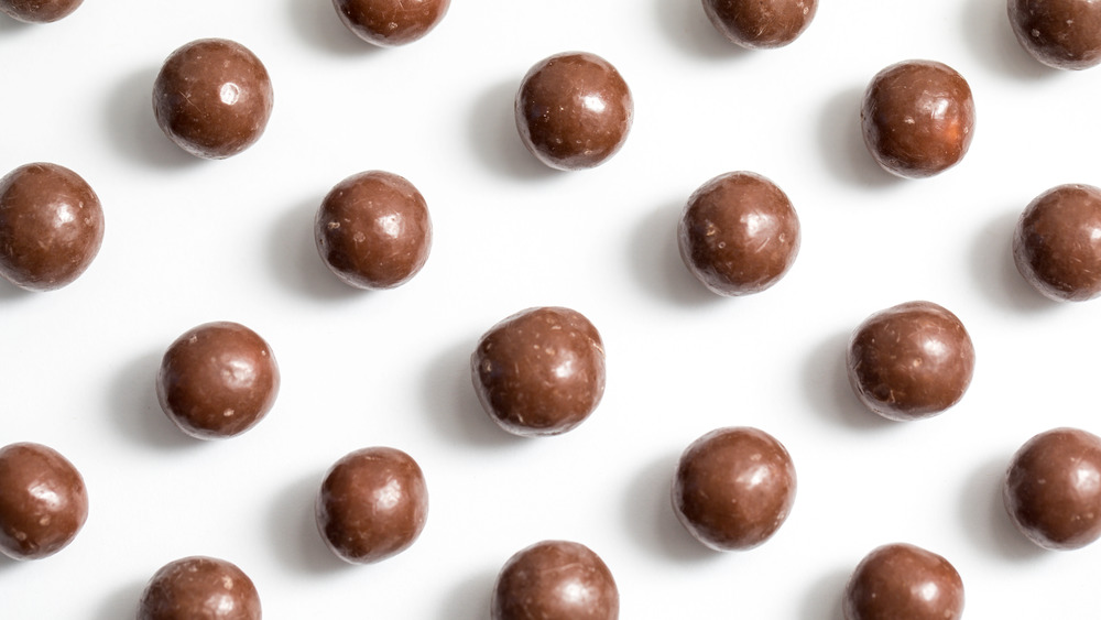 Whoppers candy pieces on a white counter