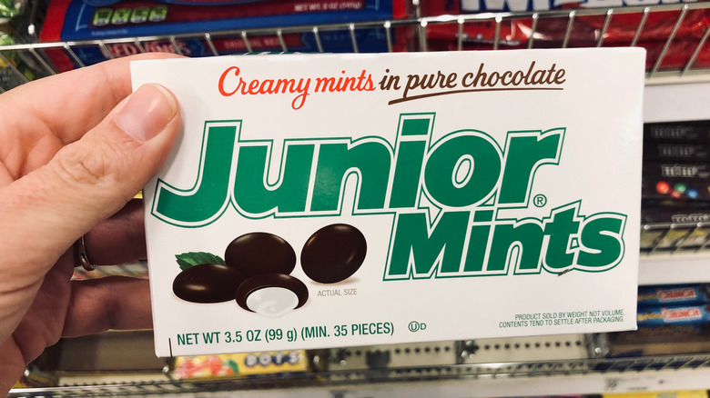 hand holding junior mints box