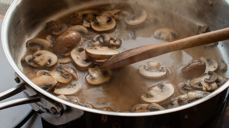 mushrooms cooking in beer in skillet