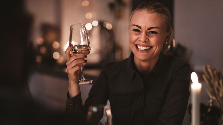 woman grinning at dinner party