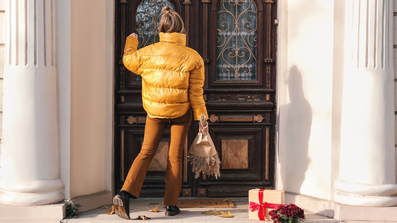 woman knocking at house door