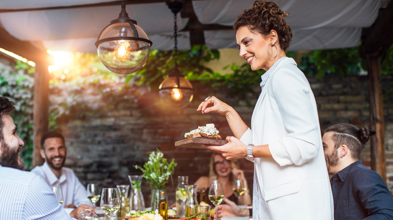 woman serving food at dinner 