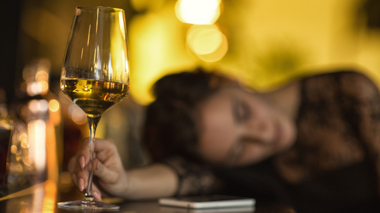 woman asleep with wine glass