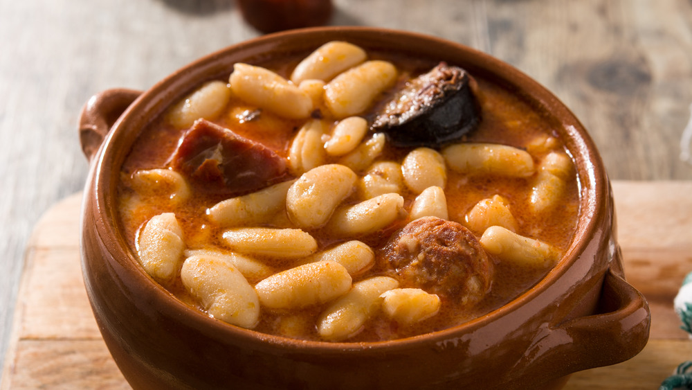 Beans and meat inside brown ceramic crock