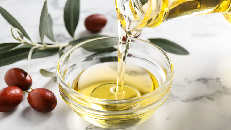 pouring oil into glass bowl