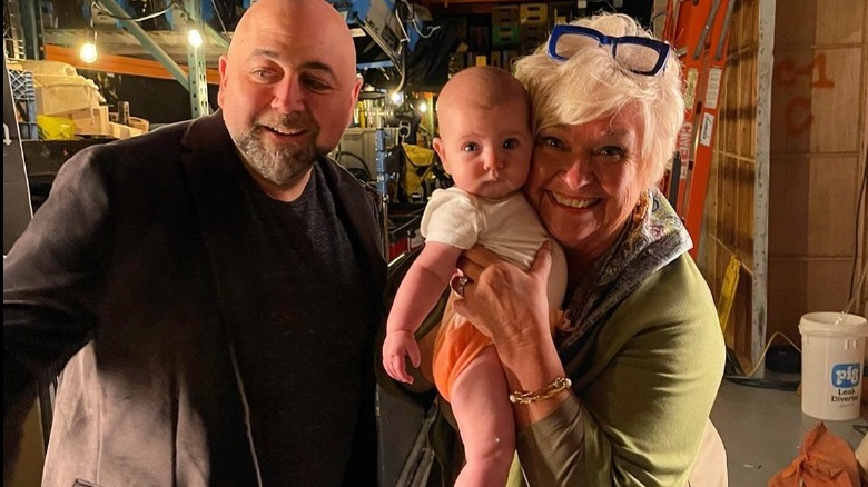 Nancy Fuller holding Duff Goldman's daughter