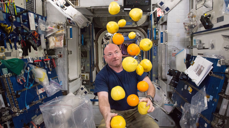 An astronaut juggles citrus aboard the ISS