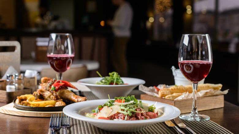 Plates of food with red wine