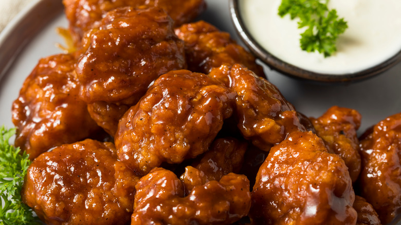 Boneless buffalo wings with blue cheese and parsley