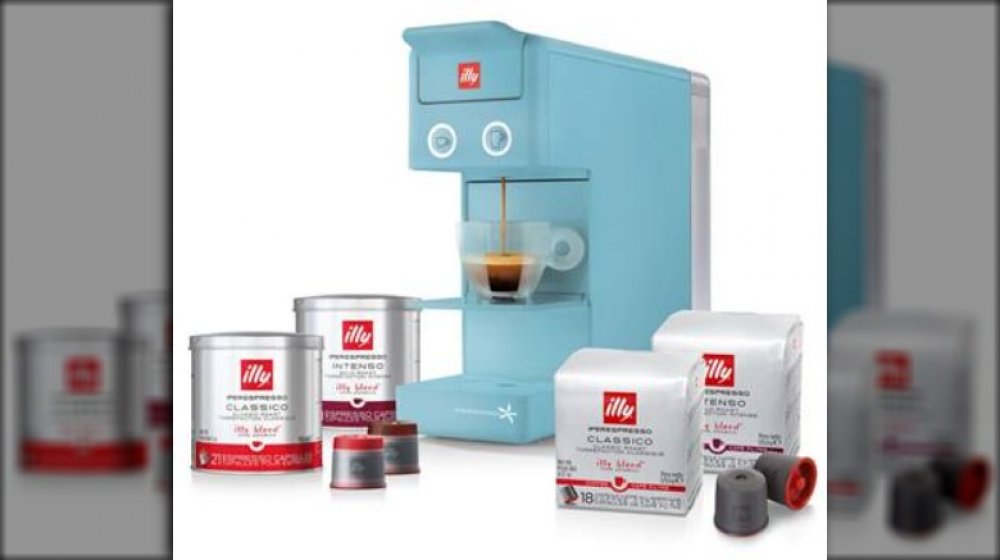 illy coffee machine with illy coffee products around it